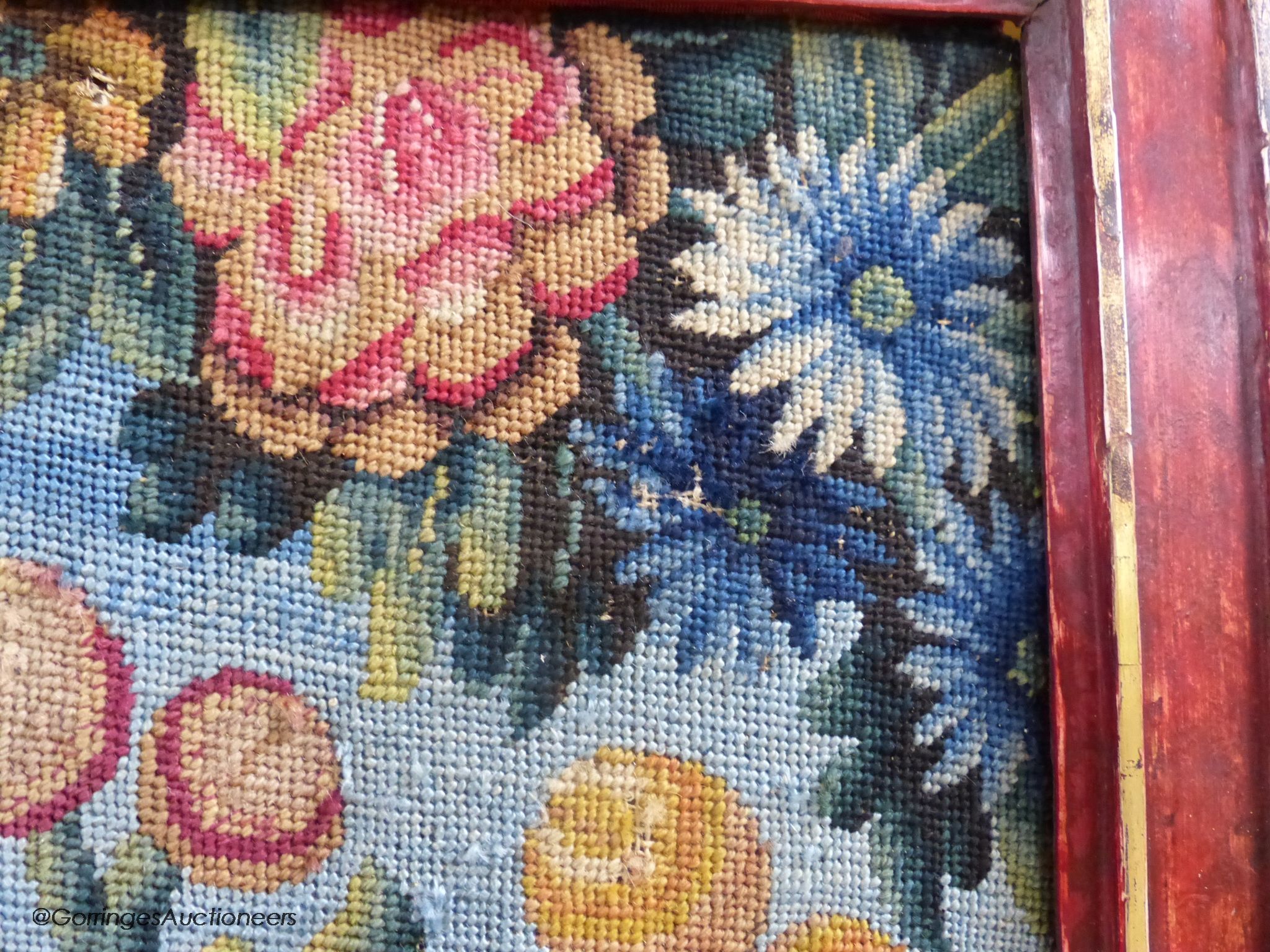 A framed 19th century woolwork panel depicting pomegranates, other fruit and flowers, 71 x 38cm
